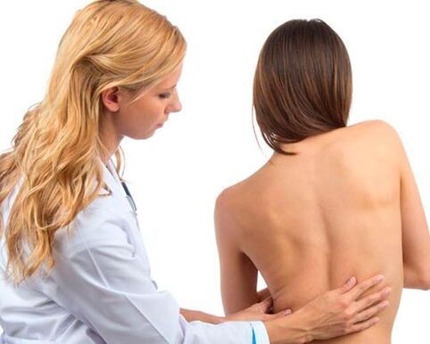 the doctor examines the back for lower back pain